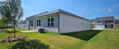 Back of property featuring a yard, central AC, and