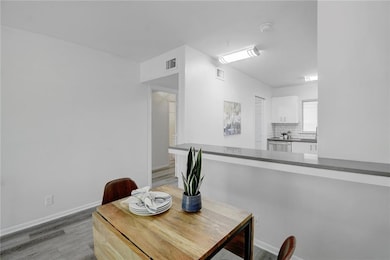 Dining room featuring baseboards, light wood-type