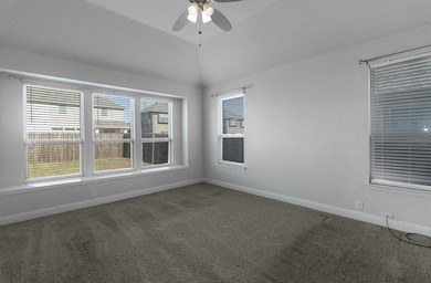 Unfurnished room with carpet flooring, a ceiling fan, and vaulted ceiling