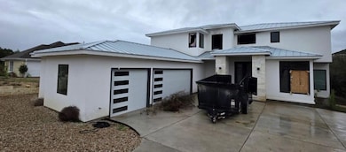 View of front of property featuring a metal roof,