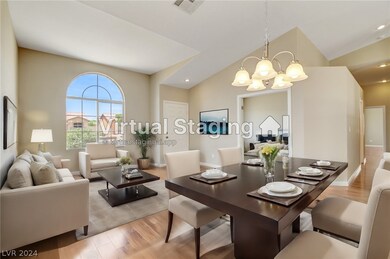 Living and dining room areas with an adjacent den