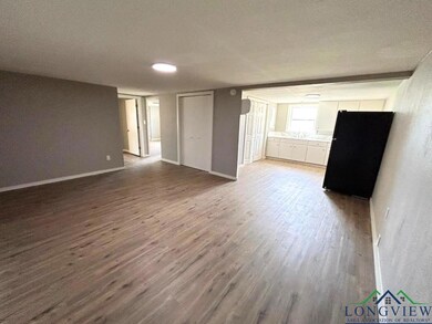 Unfurnished living room featuring baseboards and w