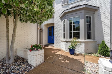 Doorway to property featuring a patio