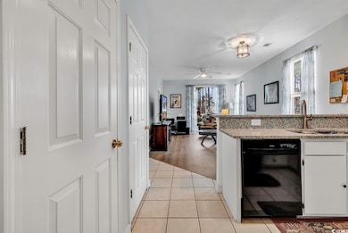 Kitchen with white cabinetry, light wood-type floo