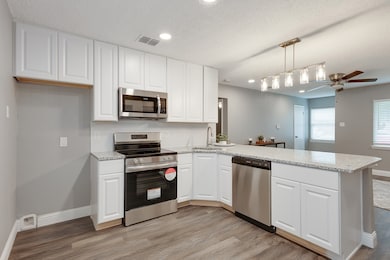 Stainless Steel Appliances. Kitchen peninsula provides more eating area.