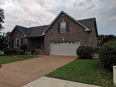 2 car garage with aggregate driveway and side entrance.