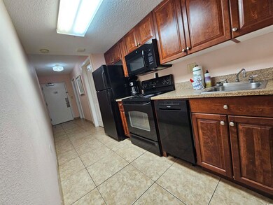 Kitchen featuring sink, light tile patterned floor