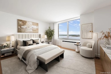 Bedroom featuring light wood-style flooring and a water view