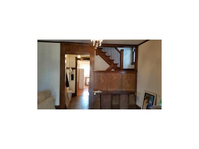 Entry way with original woodwork and hardwoods.