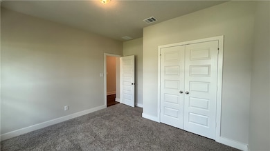 Unfurnished bedroom featuring dark colored carpet