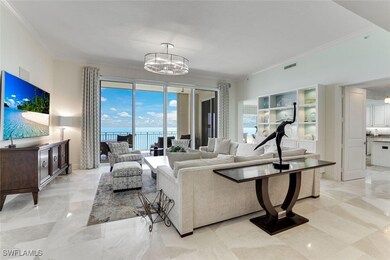Living area with crown molding, a chandelier, a wa
