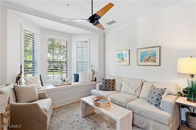 Living room featuring ceiling fan, baseboards, and