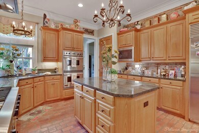 Open kitchen with sub zero refrigerator, double ov