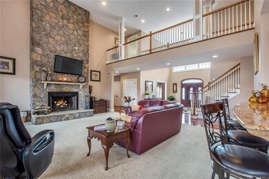 The Great Room Features a Soaring 18' Stone Fireplace and Abundant Recessed Lighting