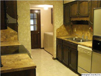 Galley kitchen with laundry off of it.