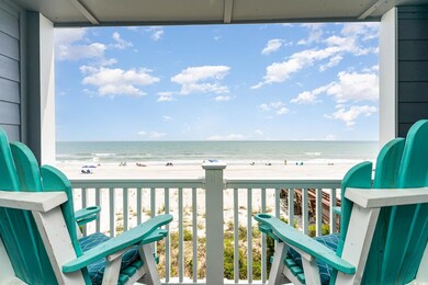 Balcony with a water view and a view of the beach
