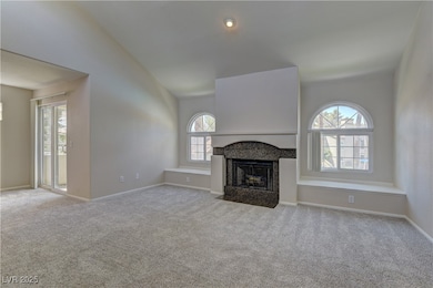 Unfurnished living room featuring lofted ceiling,