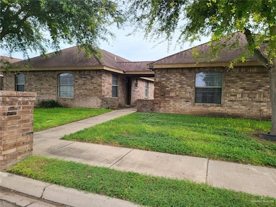 Single story home with roof with shingles, brick siding, and a front lawn