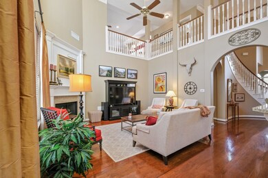 View of the family room from the breakfast area. Entry hall to the right leads you to the stair case where the secondary bedrooms, game room, upstairs craft/study, game room and exercise/storage room.