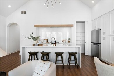 Kitchen featuring white cabinetry, sink, stainless