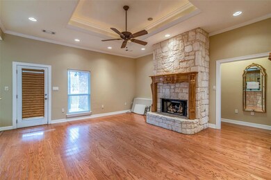 Large living area with focal point, austin stone fireplace and custom mantel.