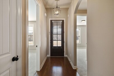 Foyer with a wealth of natural light, arched walkw