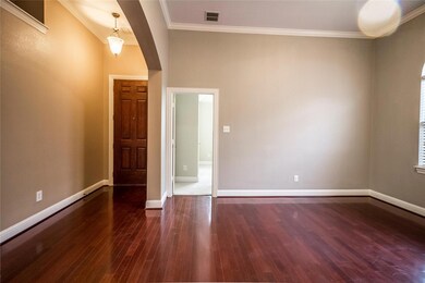 Spare room with ornamental molding and dark hardwood / wood-style floors