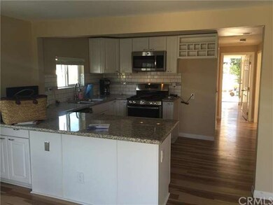 Kitchen with brand new appliances.  Looking down t
