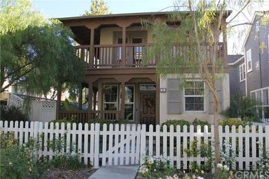 White picket fence surrounds grass area in front y