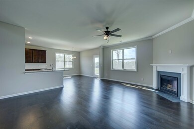 View across great room into breakfast area and kitchen.  View to backyard.  All photos are representative of a similar home.  All photos are representative of a similar home. All photos are representative of a similar home.