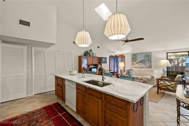 Kitchen featuring dishwasher, open floor plan, han
