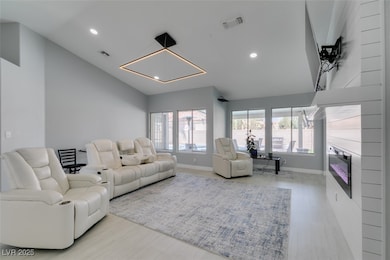 Living room featuring baseboards, recessed lightin