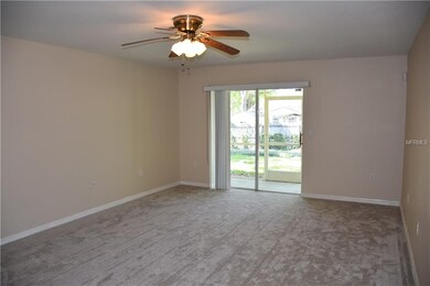 Living room with sliders to screened lanai. Storag