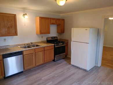 Kitchen with new gas range.  Also W/D hookup in kitchen.
