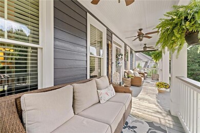 Wooden deck featuring ceiling fan, a porch, and an outdoor hangout area