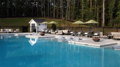 Community pool featuring a patio, fence, and an ou