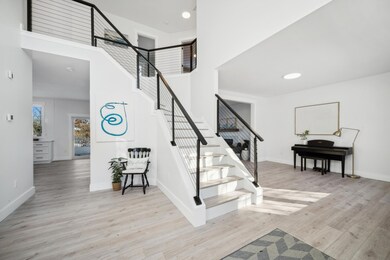 Light, bright and beautiful.  The front entry space opens to kitchen, upstairs and formal living room.