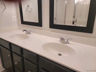 Bathroom with double sink and vanity with extensive cabinet space