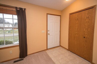 Inviting foyer area with storage closet.