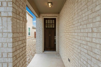 Entrance to property featuring brick siding
