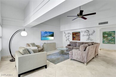 Living area with a high ceiling, baseboards, ceili
