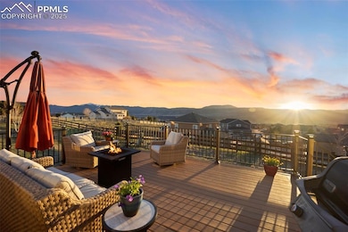 Deck with an outdoor living space with a fire pit and a mountain view