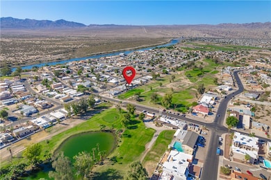 View of property location with a water and mountain view and nearby suburban area