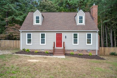 New england style home with a front lawn