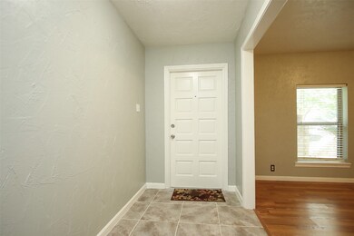 Entry has upgraded tile, recent paint throughout and opens into the huge formal dining room.