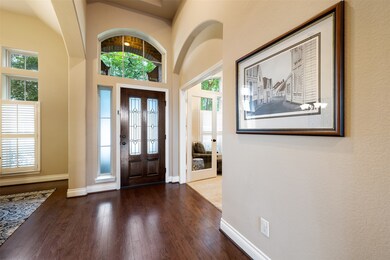 A covered front porch and beveled glass front door welcomes you inside to the foyer, where you will be greeted by soaring 13-ft ceilings and stunning hardwood floors. This home also features a built-in security system, and Cat5e wiring with a centralized patch panel for modern home network needs.