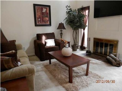 Living room w/ woodburning fireplace and vaulted c