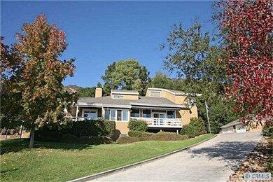 Home is set back from entrance, nestled in the hil