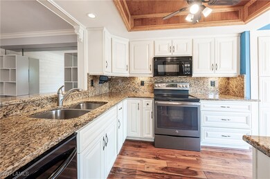 Kitchen with light wood-style flooring, ceiling fa