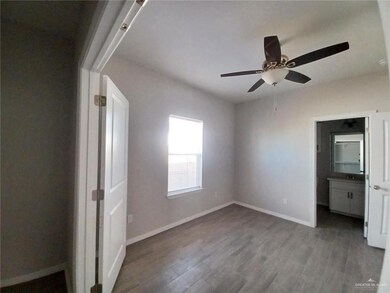 Unfurnished bedroom featuring wood finished floors, baseboards, and ceiling fan